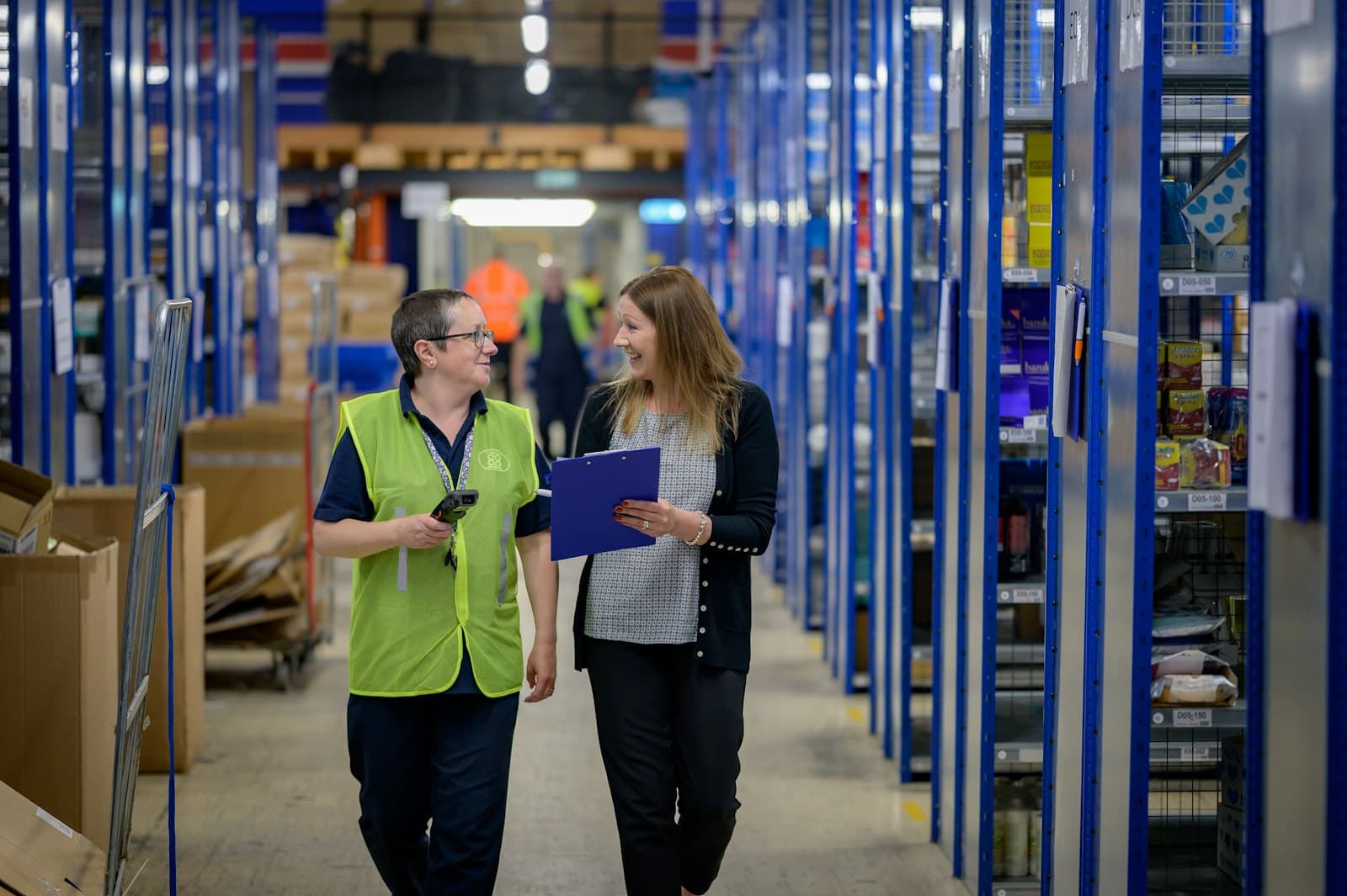 Alpha Ace warehouse team reviewing stock together on the floor